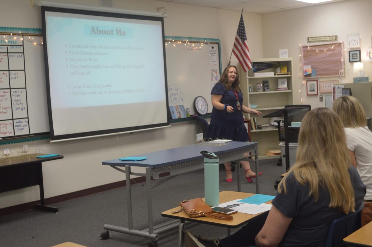 Anna Collins is speaking to the parents of her students at Open House, Aug. 3. Collins explains the curriculum expected of the seniors in her class as well as the policies that she implements within her classroom.  