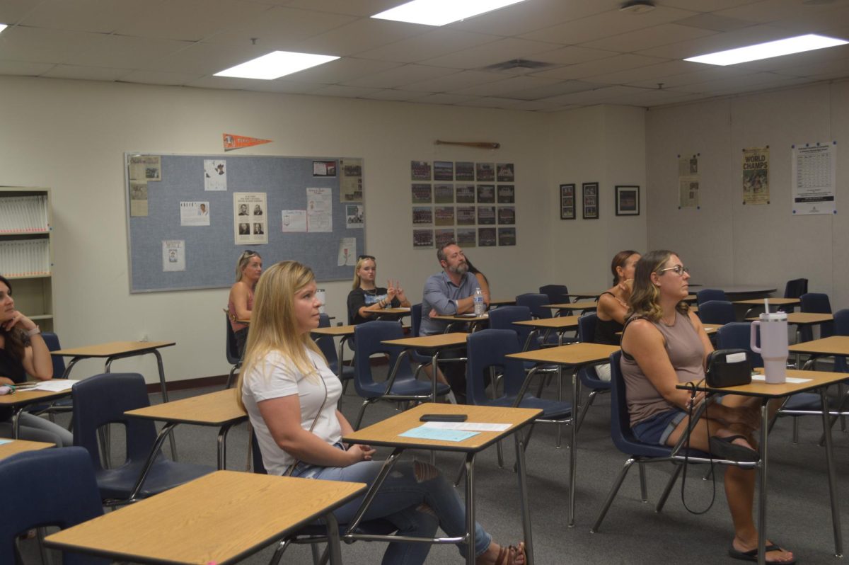 Parents listen to Mr. Damien Tippett as he informs the parents of his sophomore students during Open House.  Most of which consists of the curriculum their students will be learning throughout the year. 