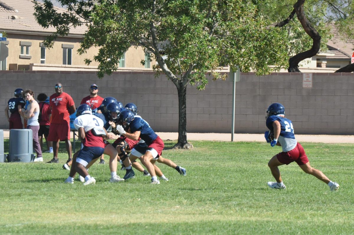 Junior Maddox Ford attempts to evade the defense on a kick return in practice. During this practice, the defense was able to tackle Ford due to the new equipment.