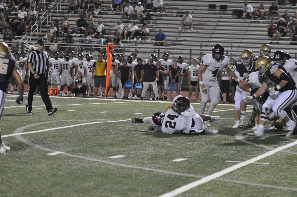 Junior linebacker Jaiden Quiba (#24) makes a fumble recovery. The defense was ready for some plays from the opposing team, as sophomore Tanyon Erdman stated, “[We were] going against their plays on defense.”
