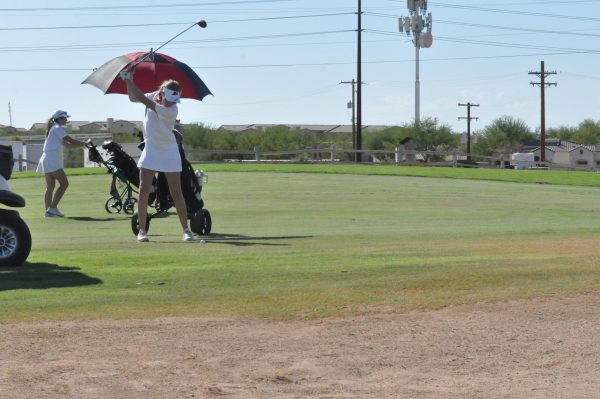 Junior Harper Mowry, takes a shot during match against Casteel High School. The boys and girls golf team is aiming for victory this season.