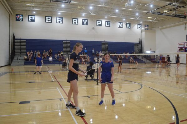 During the badminton match against Mountain View high school on Aug. 24 junior Ellie Martin and her opponent are together laughing in between their respective matches. The entire match between the schools resulted in a 7-2 win.