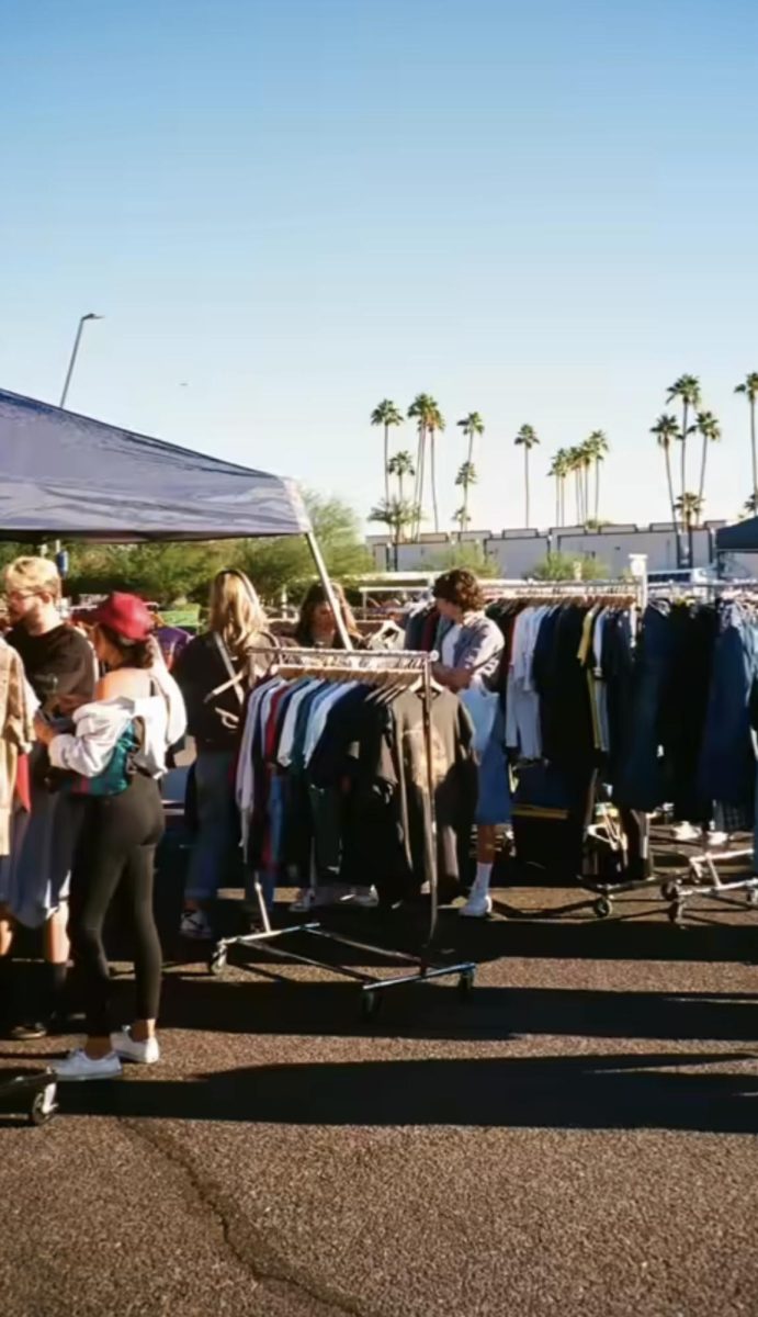 Members of the community gather outside of Wangs Closet in Tempe for the bi-monthly Sunny Day Market at the store. Vendors range from adult members of the community, to college and high school students.