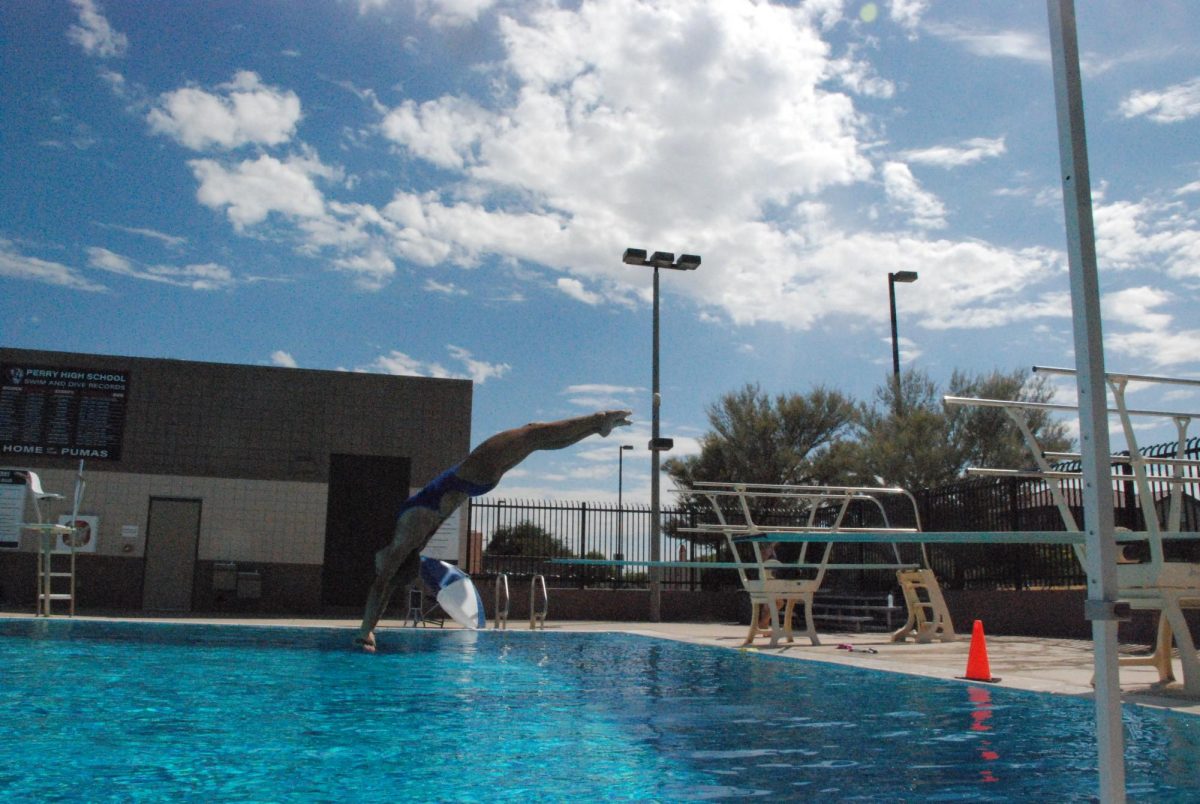 Sophomore Zoey Kunz back dive tucks, which sees the diver jump off the board and then pull their legs towards them. Her and her teammates are prepared to go all out this year despite the lack of people on the team.