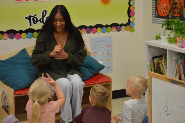 Senior Ria Siddappa teaching children in the 4’s room at the Little Explorers daycare sign language. Siddappa taught them basic signs and the alphabet. 