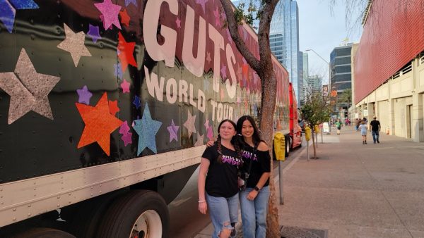 Sophomore Abigail Insua poses with her cousin in front of a ‘GUTS’ Tour bus. The concert was an exciting experience for Insua because she is an avid listener of Olivia Rodrigo.