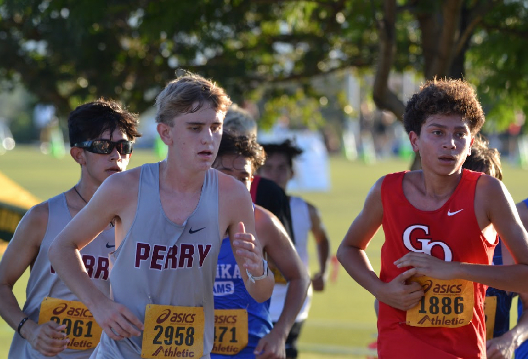 Freshman Christian Fluckiger runs alongside opposing schools in Woodbridge, California. The cross country team completed the regional meet on Sept. 20.