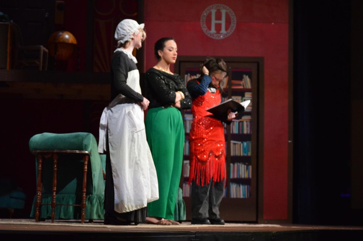 Junior Cassie Tanner, senior Brynlee Olley, and senior Taylor Pearce act center stage. They stand there discussing who they believe the murderer is in the play "The Play that Goes Wrong"is an understaffed, underfunded, and comedic murder mystery.
