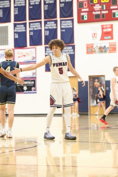 Sophomore Thaddius Egorerua played against Casteel High School on Jan 14, 2025. Perry beat Casteel with a final score of 71-44, Egorerua is seen congratulating another player during the game.
